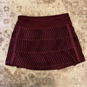 Burgundy and black Lululemon workout skirt.